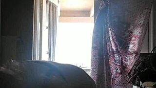 she rubs lotion on her skin.