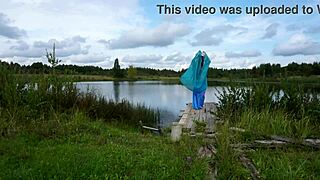 In the second photo, a mature woman is wearing a piece of lingerie and laying on a lake