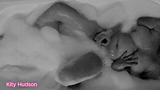 KITY HUDSON ENJOYS BATH WITH TOY