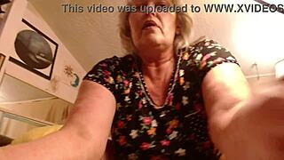 A mature amateur with big tits and a big ass shows her beaver while smoking a cigarette