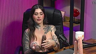 A adult film actress with an amazing set of large natural breasts with tattoos gets a cock in her mouth