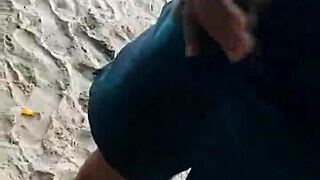 Exhibitionist couple bangs on public beach as stranger joins to finish