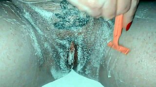 Milf carefully shaves her trimmed pussy with soap