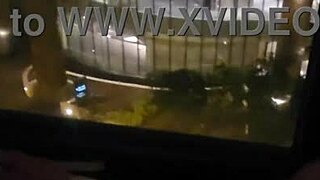 Petite babe masturbates in public by hotel window for thrill