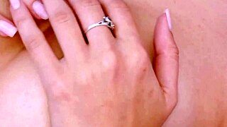 The enchanting brunette beauty displays her sexy body on the sofa.