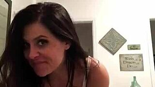 at home, a tattooed milf strips down slow, revealing big tits for fun
