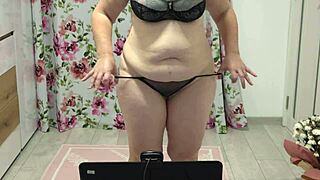 Juicy chubby milf shakes in panties near webcam, showing off her curvy figure with home fetish vibes.