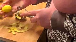 Chubby milf in lingerie gives handjob in the kitchen with her big natural tits