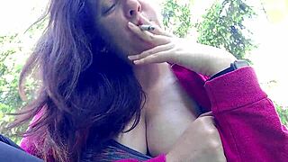 i'm nicoletta smoking in a public garden flashing my big tits outdoors
