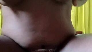 African girl feels intense pleasure masturbating in her bedroom.