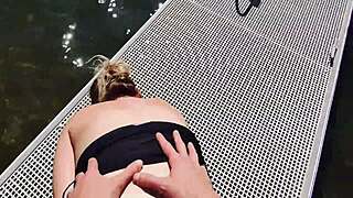 Couple risks getting caught fucking outdoors at the lake. They expose big natural tits and perform blowjob for anyone to watch.