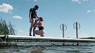 Couple risks getting caught fucking outdoors at the lake. They expose big natural tits and perform blowjob for anyone to watch.