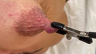 He torments her bound dark nipples with hard squeezes and stretches